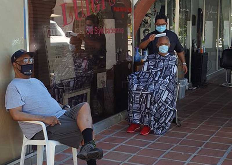 Barber Cuts Hair Outdoors on Historic Plaza